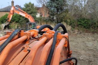 Close-up of heavy construction machinery like excavators and cranes in action on a building site.