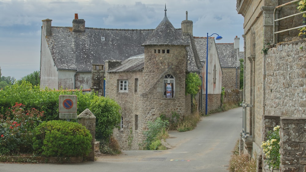 a stone building with a sign in front of it