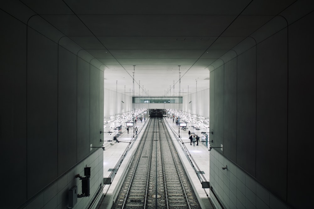 a train station with people walking