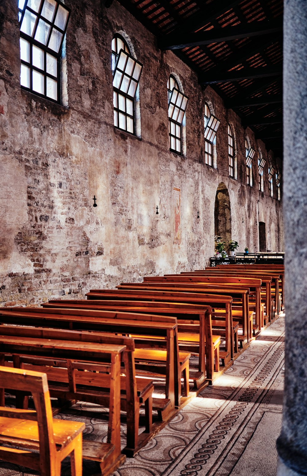 a row of wooden benches in a church