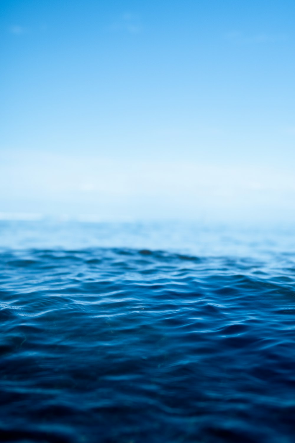 a body of water with a blue sky above it