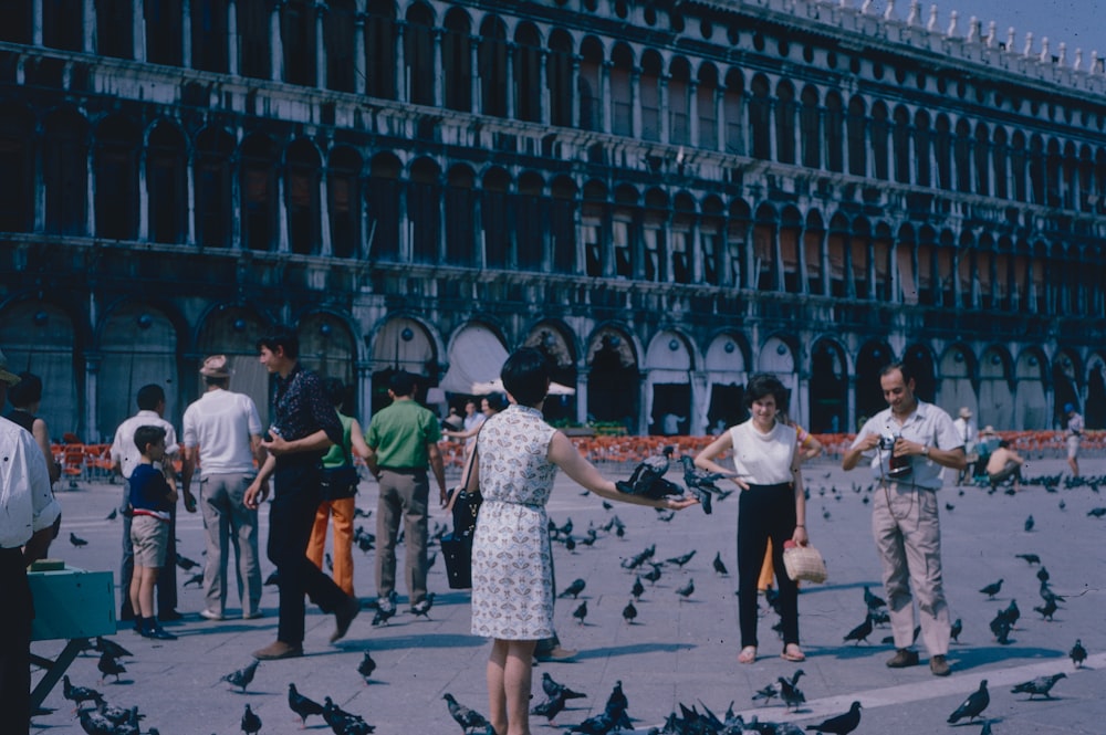 a group of people dancing in front of a building