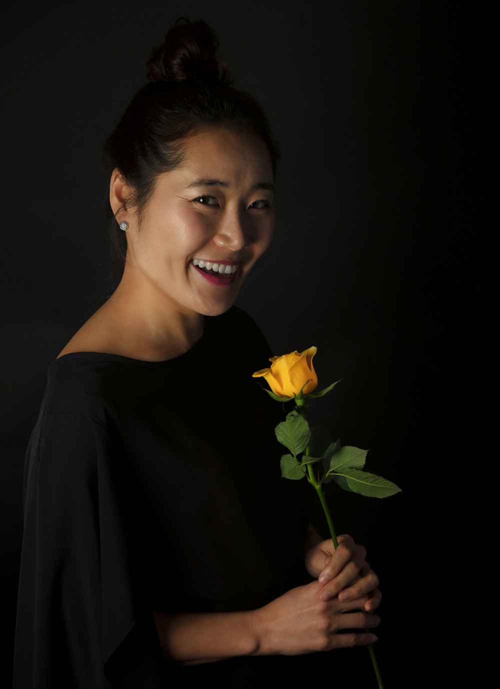 a person holding a yellow flower