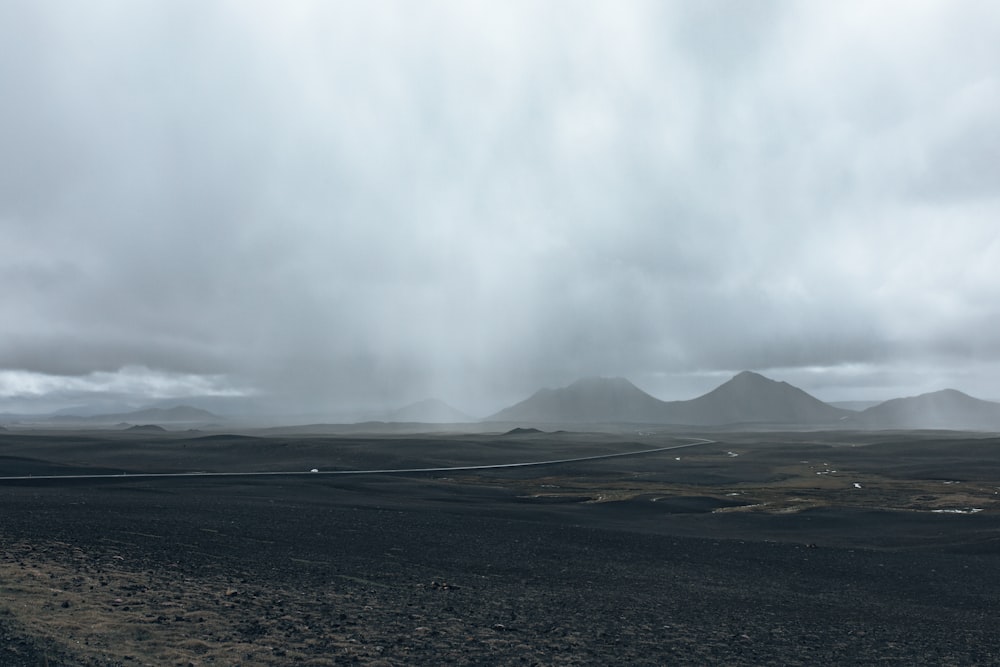 a landscape with mountains in the back