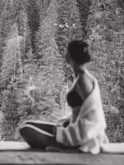 a person sitting on a ledge