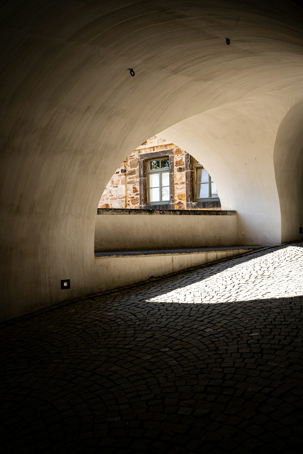 a stone walkway with a window