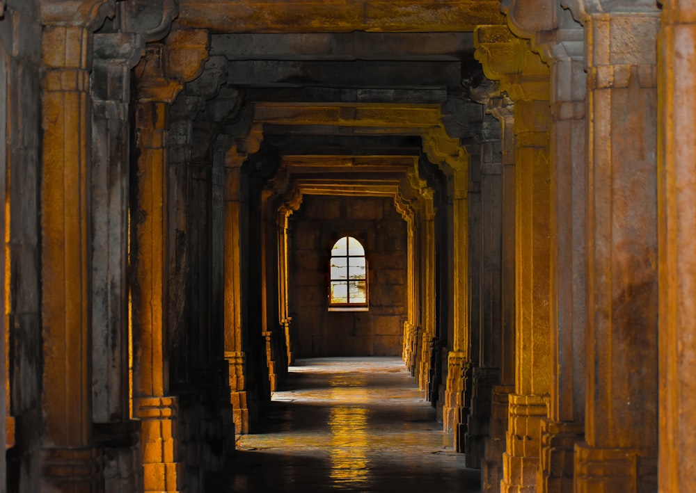 a hallway with arches and columns