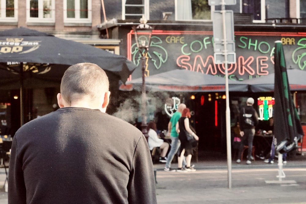 a man stands under an umbrella