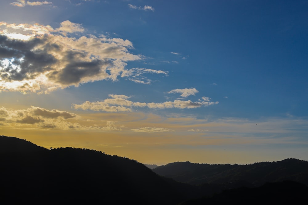 a landscape with hills and clouds