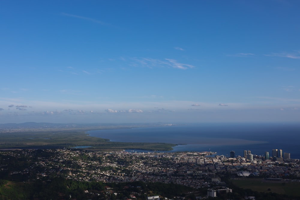 a city with a body of water in the background