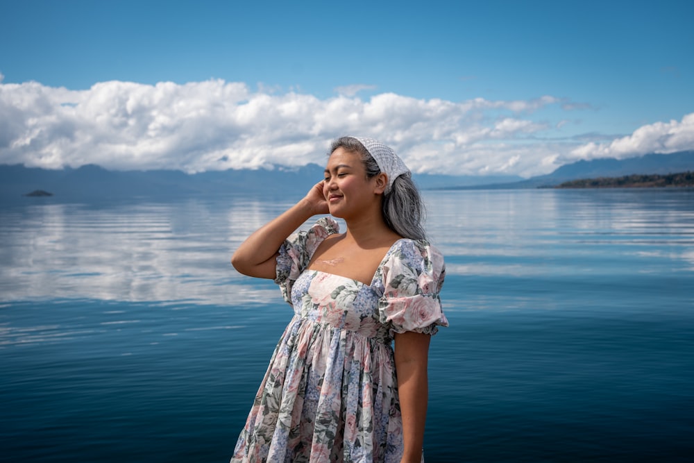 a woman standing in front of water