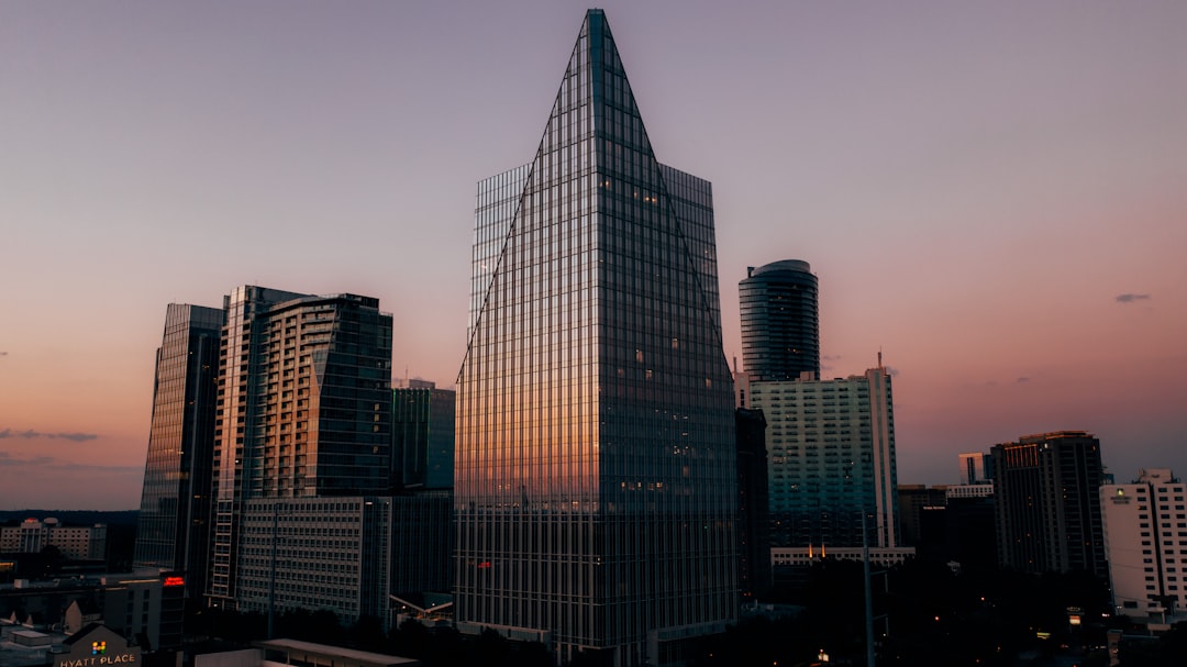 a city skyline at sunset, Photo by Lance Asper
