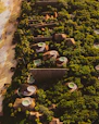 Elegant beachfront luxury villa with a sparkling private pool overlooking the ocean at sunset.