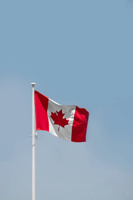 a red and white flag on a flagpole