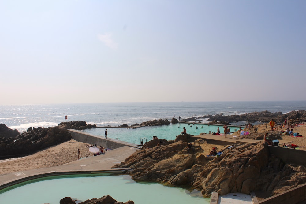 a beach with people and rocks