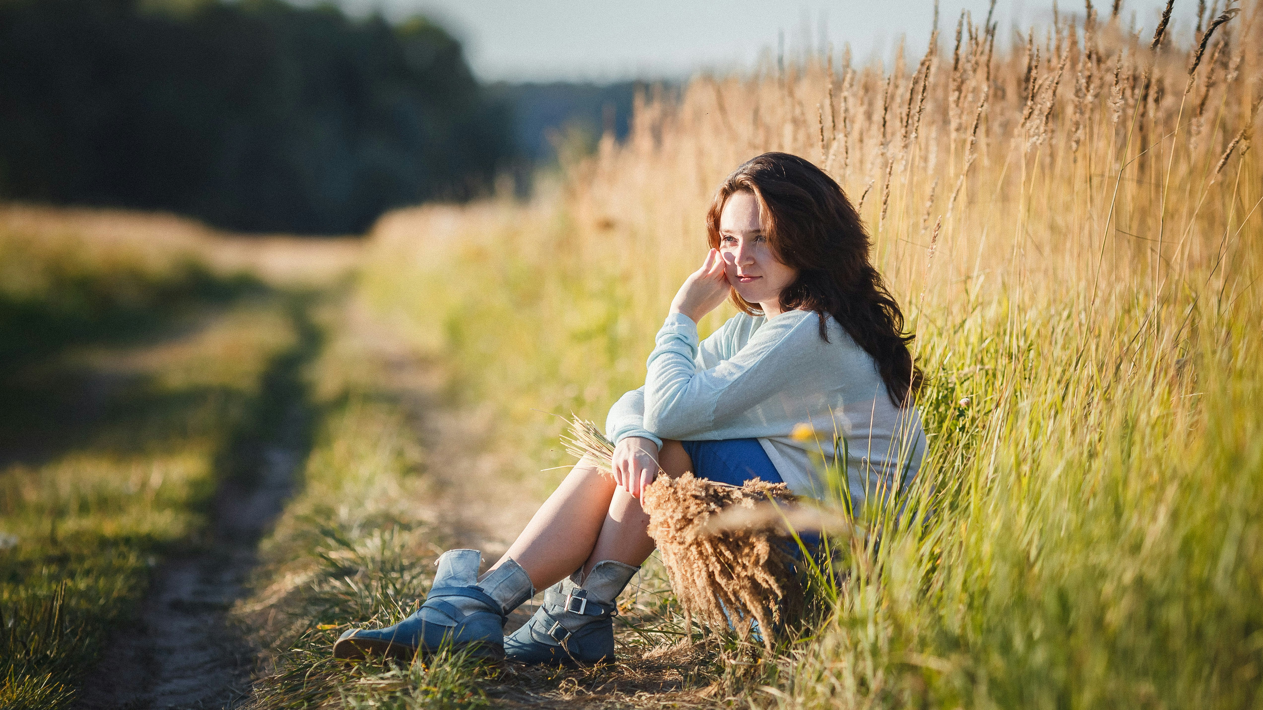 a man sitting in a field