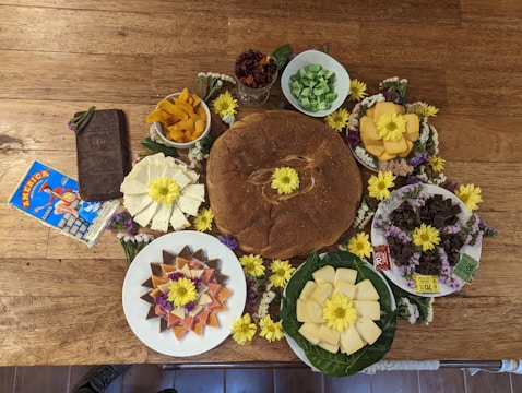 A vibrant display of assorted fresh European food products arranged on a rustic wooden table.