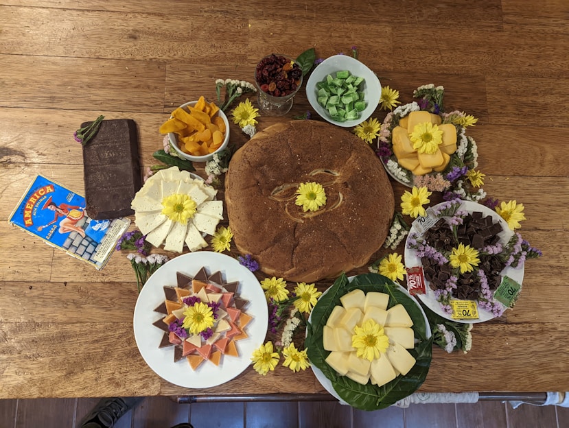 A vibrant display of imported snacks, breads, and dairy products arranged invitingly on a rustic wooden table.