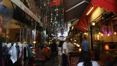 A bustling market street in Marrakech filled with colorful textiles and spices.