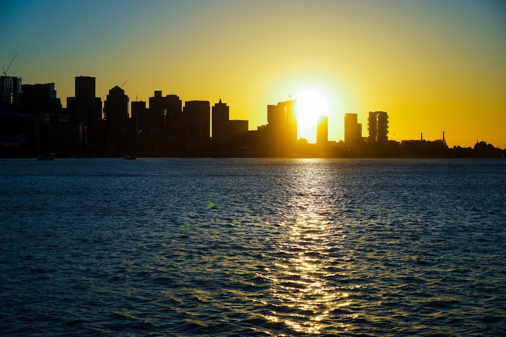 a city skyline with the sun setting