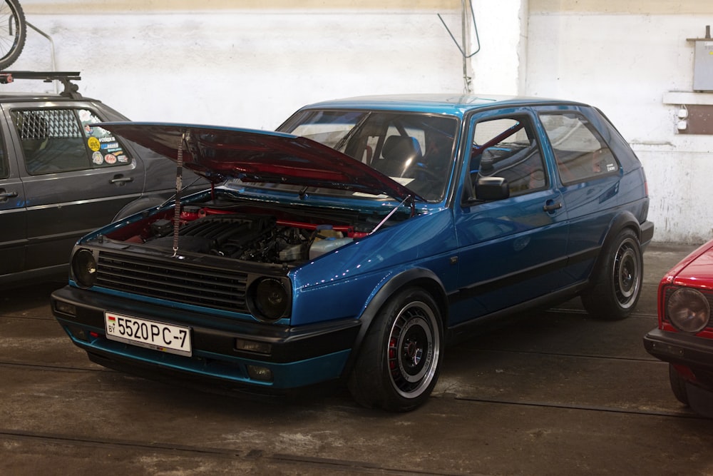 a blue car with its hood open