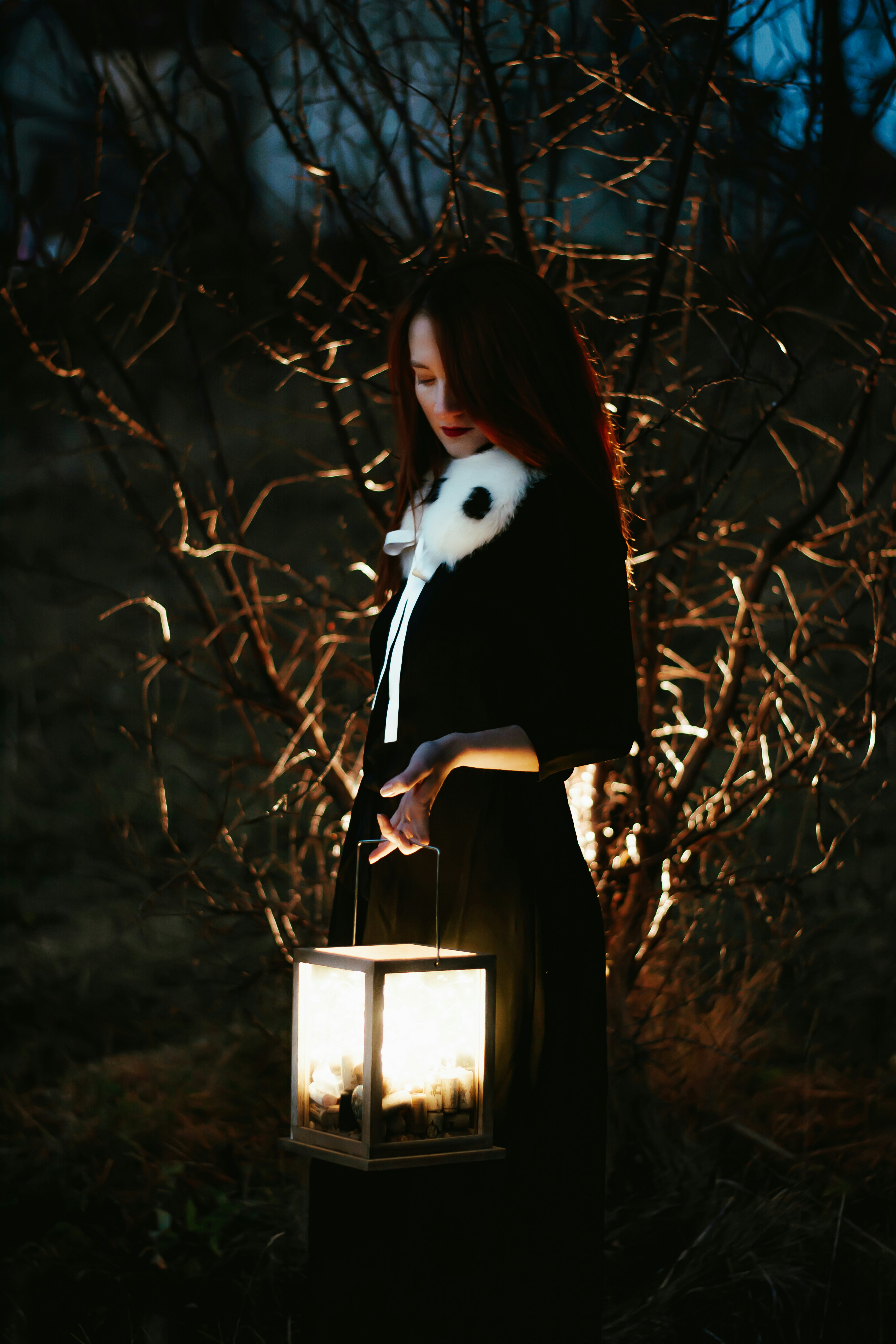 a person holding a lantern