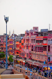 A vibrant street scene in India showcasing colorful markets and historic architecture.
