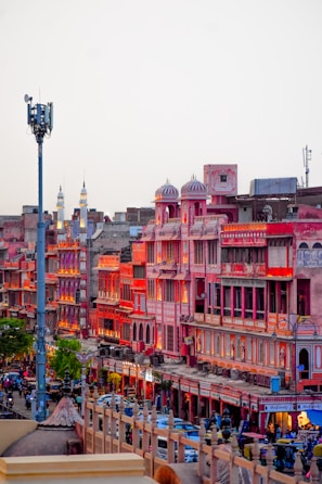 A vibrant street market bustling with colors in Rajasthan under warm sunlight.