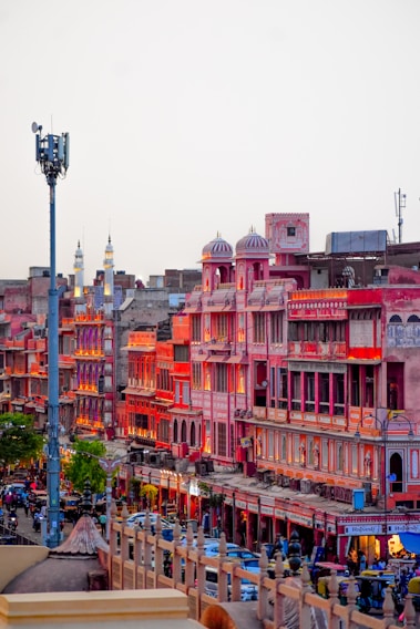A vibrant street market scene in Jaipur bustling with colorful textiles and lively crowds.