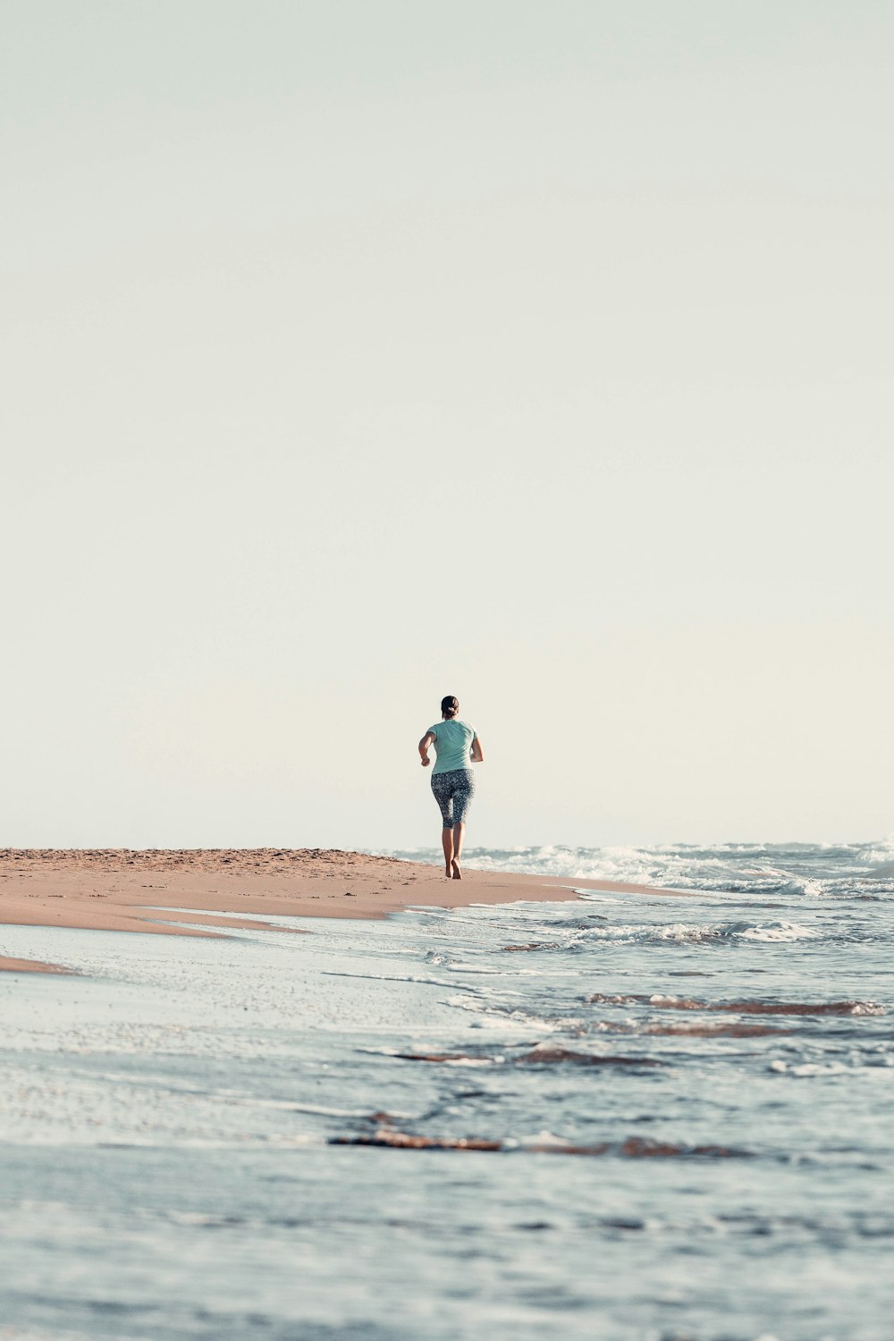 a man walking on a beach