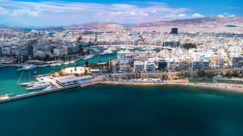 Coastal Greek village on the water with pastel harbour houses