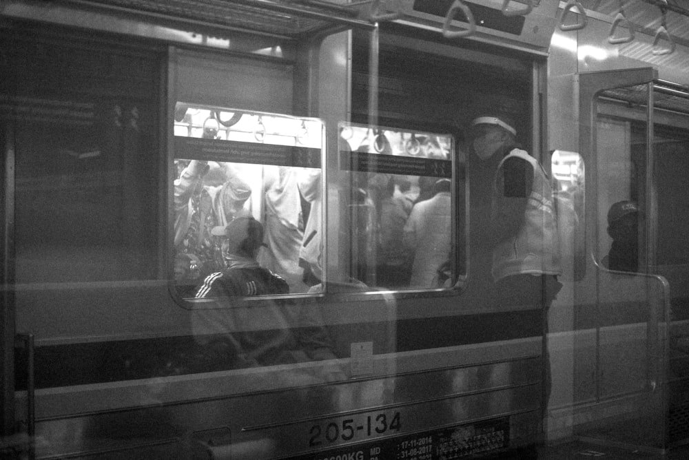 a group of people ride on a subway