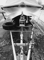 A heavy-duty hot-dip galvanized boat trailer loaded with a fishing boat on a rural road.