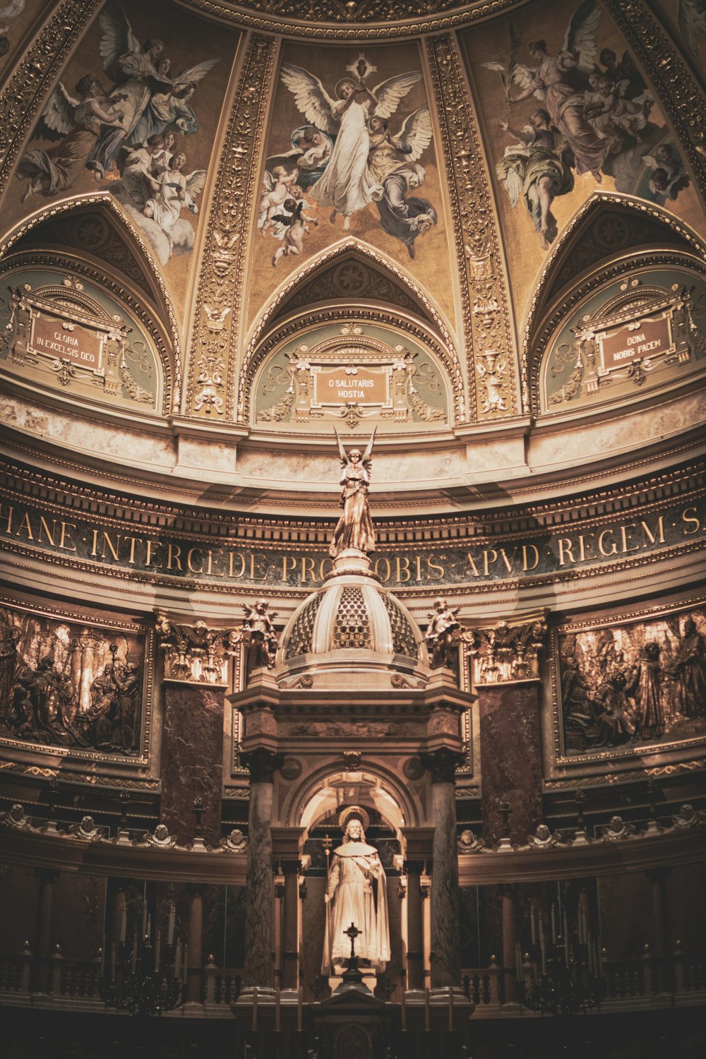 a statue in a room with paintings