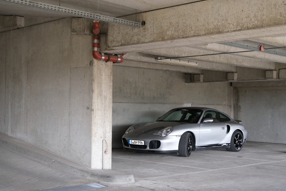 a silver car parked in a parking garage