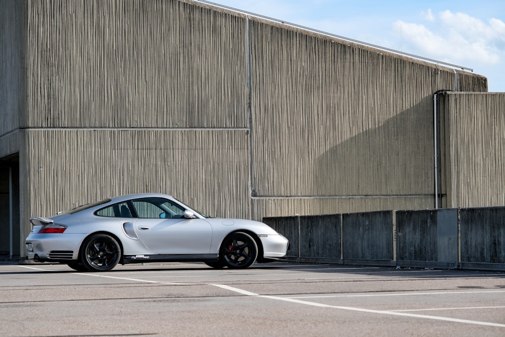 a white car parked in front of a building