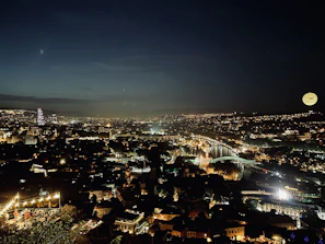Night view of a vibrant university cityscape with modern buildings and lights