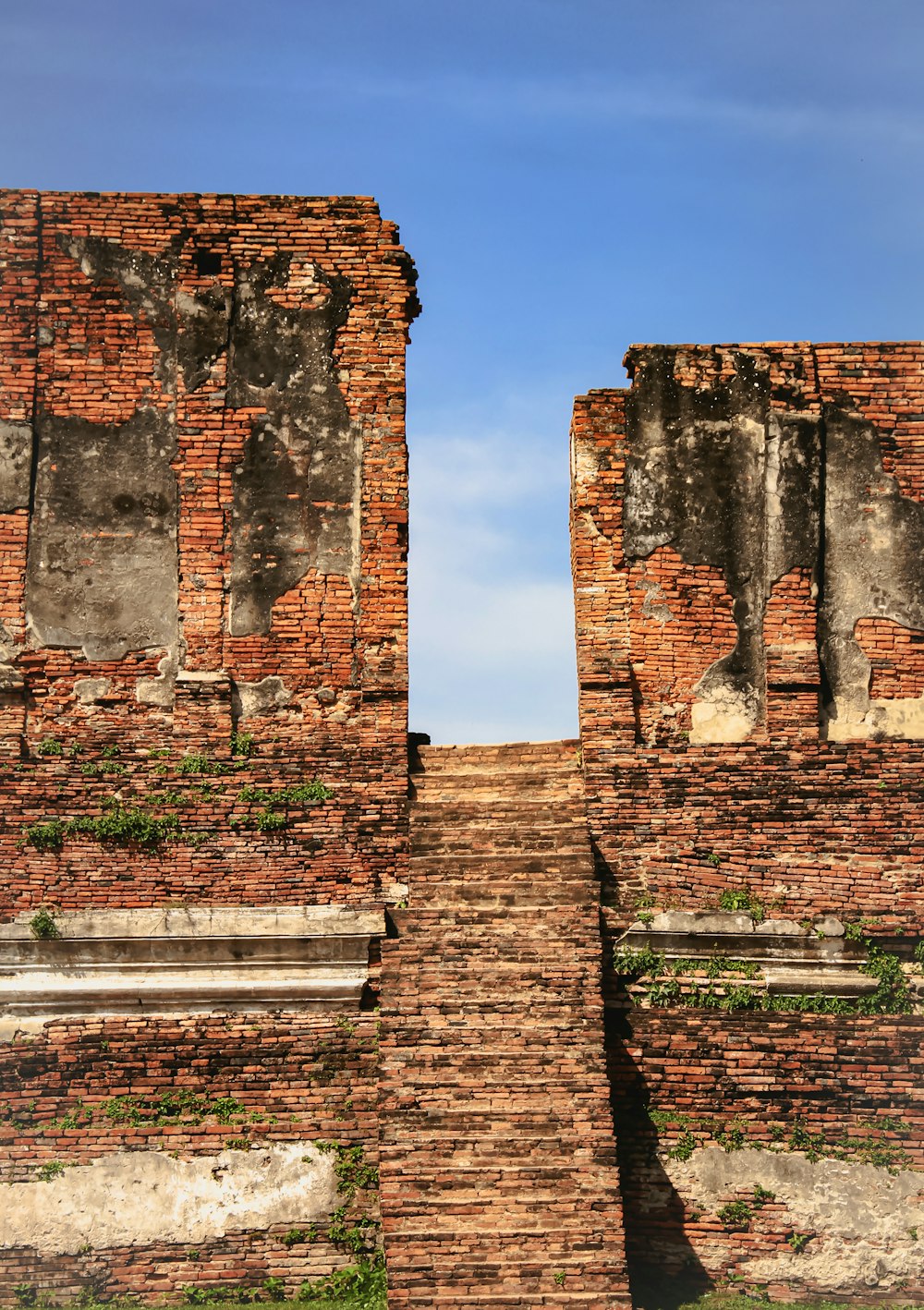 a brick wall with a stone staircase