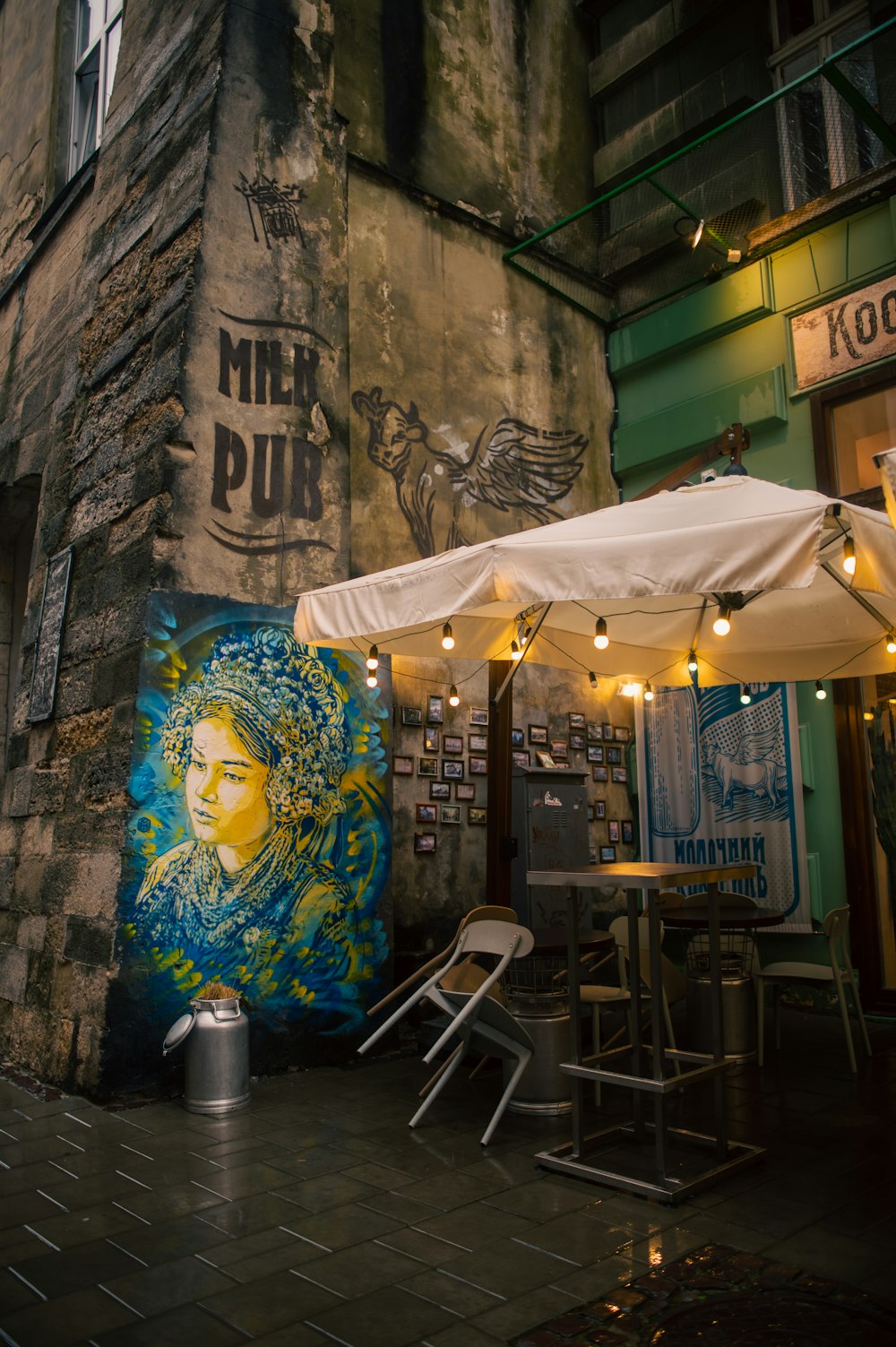 a white umbrella sits over a table