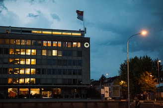 An inspiring office view showing the Innoscale Solutions logo illuminated against a city skyline at dusk.
