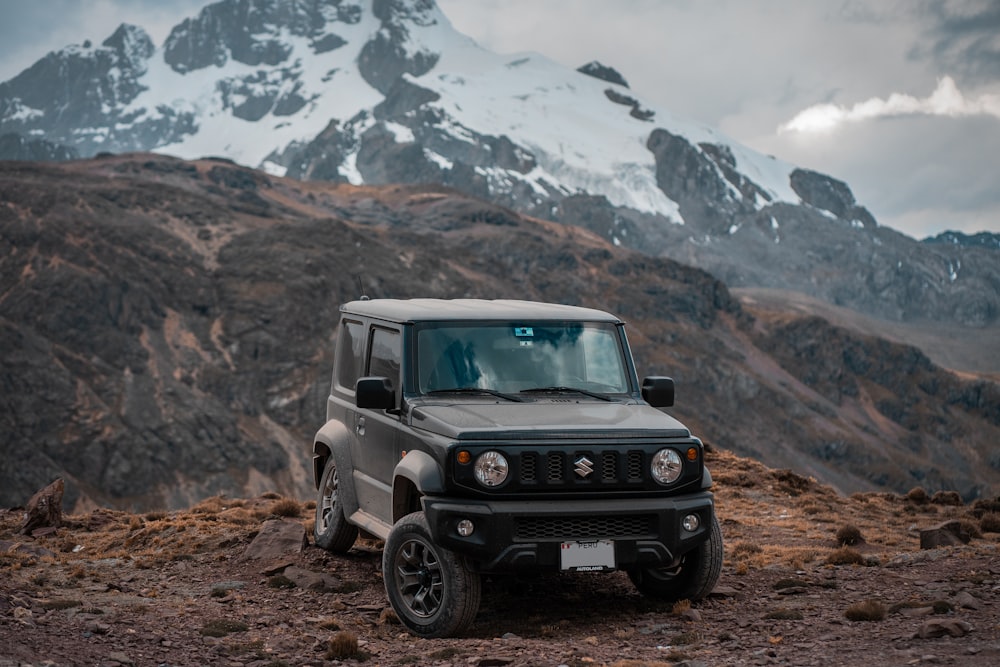 a jeep parked on a rocky hill