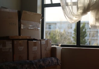 a room with boxes and a window