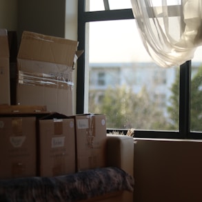 a room with boxes and a window