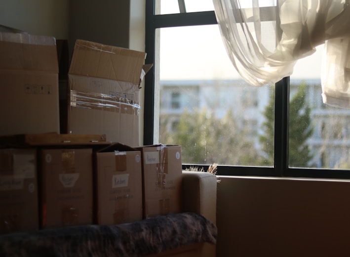 a room with boxes and a window