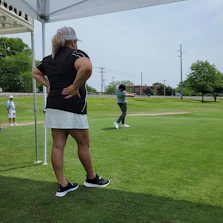 Friendly Swingvista team member setting up the mobile golf simulator at a corporate event.