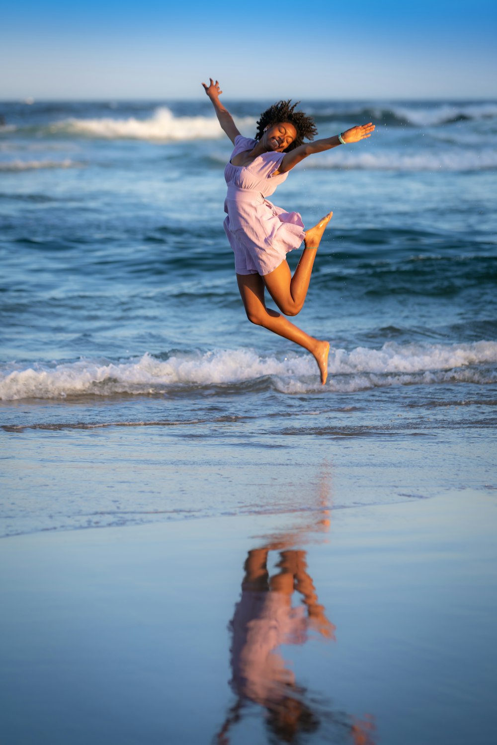 a man jumping in the air on a beach