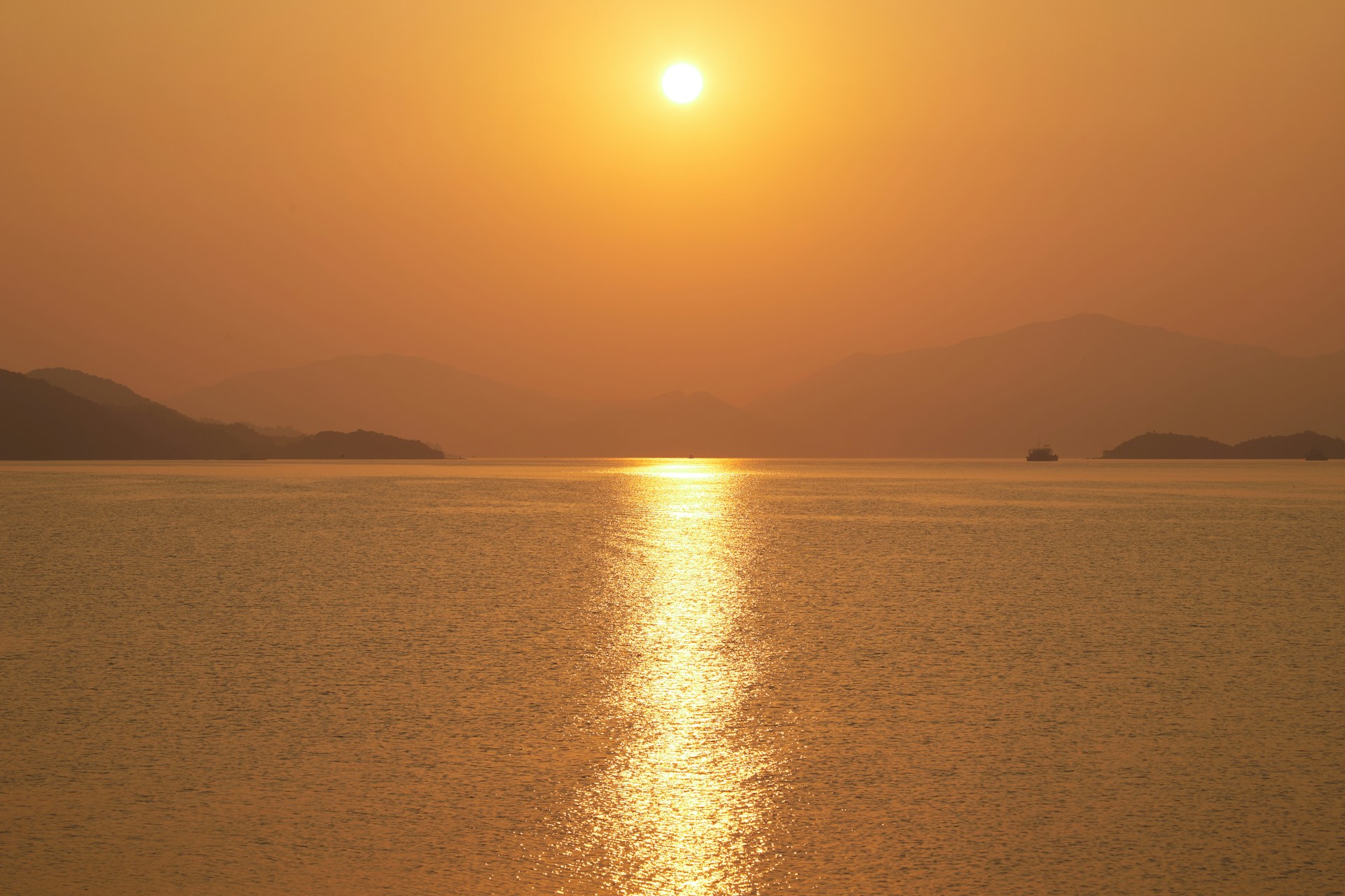 a body of water with hills in the background