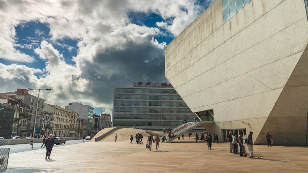 a group of people walking around a large building