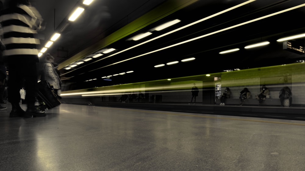 people with luggage in a train station