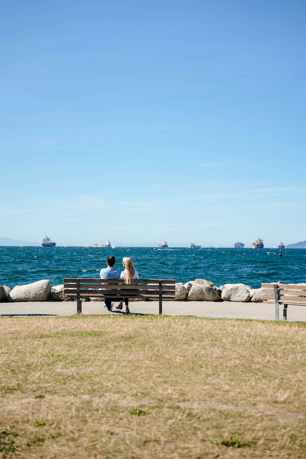 a couple sitting on a bench